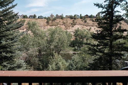 a view of a hill with trees and houses at Explore Relax Repeat - Riverside Views - Eagle in Eagle