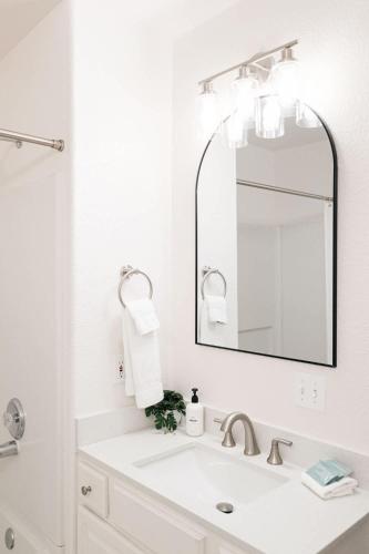 a white bathroom with a sink and a mirror at Explore Relax Repeat - Riverside Views - Eagle in Eagle