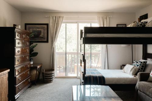 a bedroom with a bunk bed and a couch at Explore Relax Repeat - Riverside Views - Eagle in Eagle