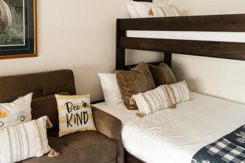 a bedroom with a bed and a couch with pillows at Explore Relax Repeat - Riverside Views - Eagle in Eagle