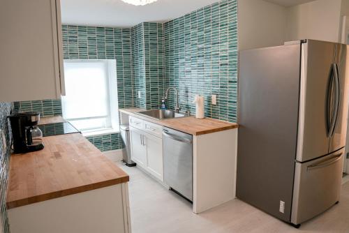 a kitchen with a stainless steel refrigerator and a sink at Luxury Penthouse -3 Blocks to Boardwalk, Outlets, & Casinos - Near AtlantiCare in Atlantic City
