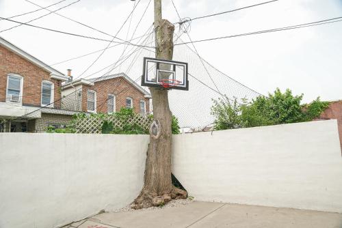 a basketball hoop attached to a tree next to a fence at Luxury Penthouse -3 Blocks to Boardwalk, Outlets, & Casinos - Near AtlantiCare in Atlantic City