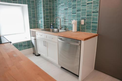a small kitchen with a sink and a dishwasher at Luxury Penthouse -3 Blocks to Boardwalk, Outlets, & Casinos - Near AtlantiCare in Atlantic City