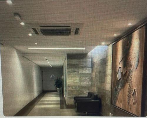a hallway with a couch in a building at S4 HOTEL AGUAS CLARAS TorresReis2 in Brasilia
