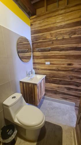 a bathroom with a white toilet and a sink at Casa Maya Mendihuaca in Playa Mendiguaca