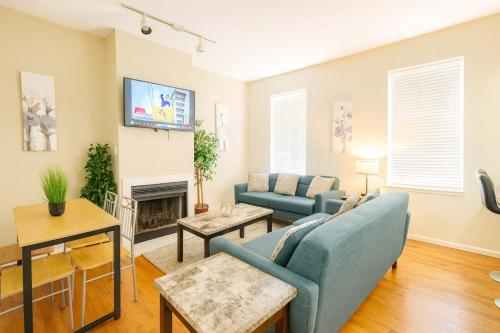 a living room with a couch and a fireplace at Spacious 4BR Soulard Duplex with Patio & Parking in Soulard