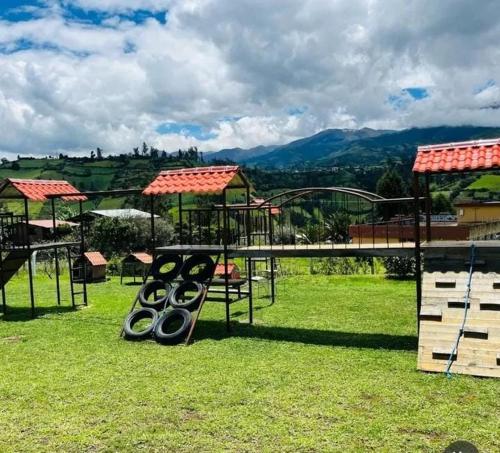 a park with a swing set in the grass at Hotel Tierra Firme in San Miguel