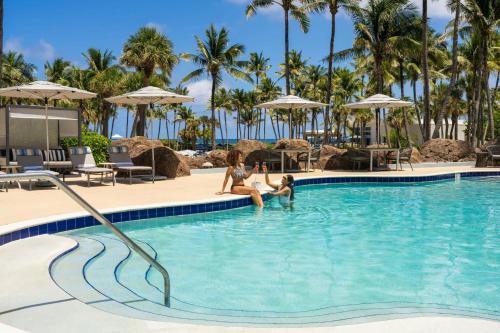 three women playing in the swimming pool at a resort at Fort Lauderdale Marriott Harbor Beach Resort & Spa in Fort Lauderdale