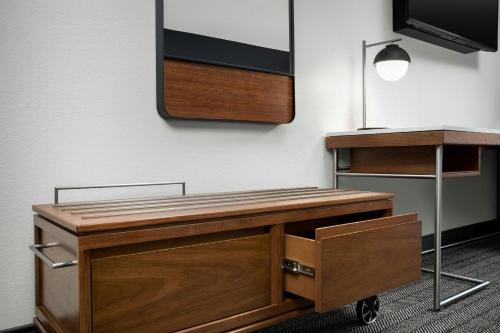 a desk in an office with a mirror on the wall at Courtyard by Marriott Bloomington in Bloomington