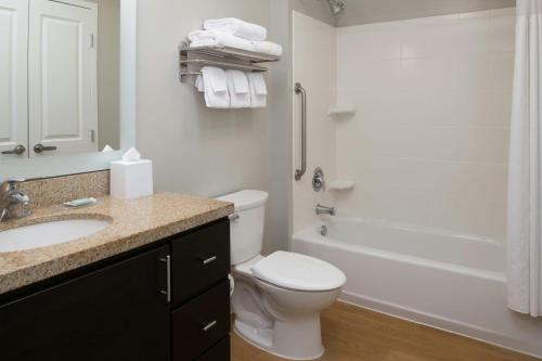 a bathroom with a toilet and a sink and a tub at TownePlace Suites by Marriott Lancaster in Lancaster
