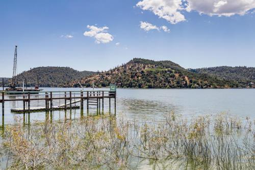 a dock on a body of water with a mountain at Watefront Getaway with Mtn Views and Dock in Clearlake in Clearlake