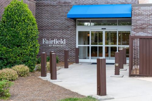 a entrance to a brick building with a blue awning at Fairfield Inn & Suites by Marriott Charlotte Airport in Charlotte