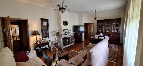 a living room with a couch and a fireplace at O cantinho do Avô Alberto