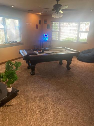 a living room with a pool table in it at The Legend Home in Oroville