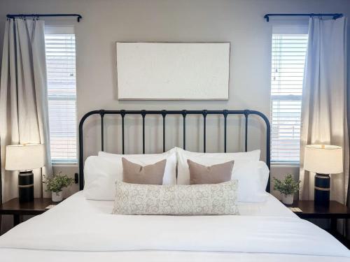 a bed with white sheets and pillows in a bedroom at The Retreat - Hot Tub Fire Pit Boat Parking in Page