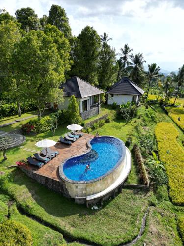 an aerial view of a swimming pool in a yard at MAYURA BALI VILLA in Munduk