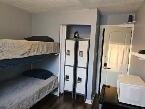 a room with two bunk beds and a mirror at Navarre Guest Rooms in Columbus