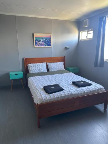 a bedroom with a bed with two towels on it at The Eulo Queen Hotel 
