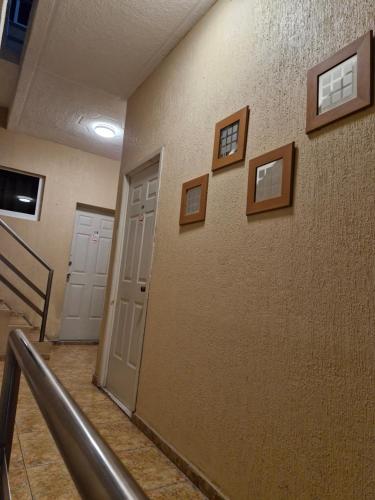 a hallway with pictures on the wall of a building at Hotel Coatza Inn in Coatzacoalcos