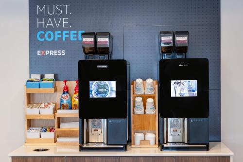 two coffee machines on a shelf in a coffee shop at Holiday Inn Express & Suites Dewitt - Syracuse by IHG in East Syracuse