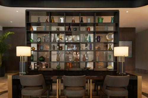 a dining room with a large wall of vases at Izmir Marriott Hotel in Izmir