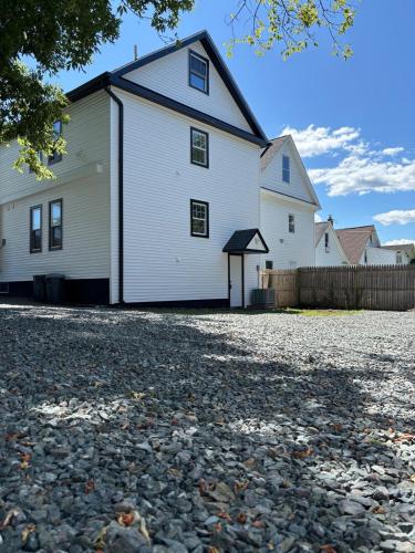 a large white house with a gravel driveway at 3 bedroom 1 bathroom apartment , free private parking in Schenectady