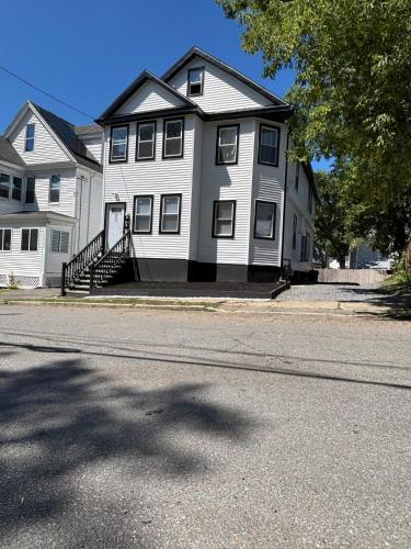 a large white house on the side of a street at 3 bedroom 1 bathroom apartment , free private parking in Schenectady