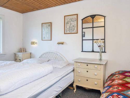 a bedroom with two beds and a dresser and a mirror at Tranquil Retreat near Beach - By Traum Ferienwohnungen in Fanø