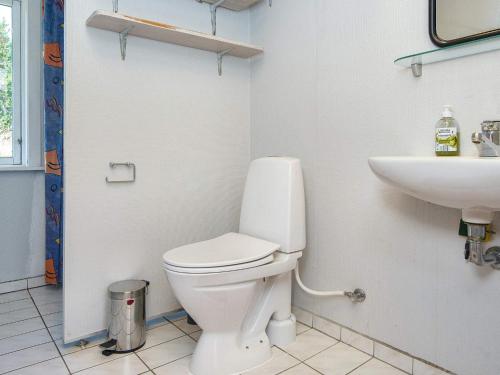 a bathroom with a toilet and a sink at Tranquil Retreat near Beach - By Traum Ferienwohnungen in Fanø