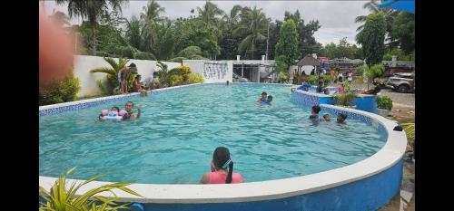 a group of people in a swimming pool at Bermuda Beach Aquatica in Daanbantayan