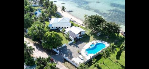 an aerial view of a house with a swimming pool at Bermuda Beach Aquatica in Daanbantayan