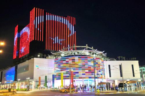 a large building with colorful lights on it at night at Marka Hotel in Antalya