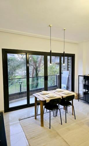 a dining room with a table and some chairs at Artistic, Cozy and bright in Madinaty