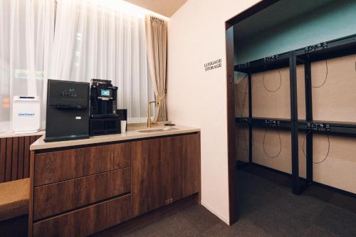 a room with a desk with a tv and a window at MONTHLIV Gwangjang Market Hotel Stay in Seoul