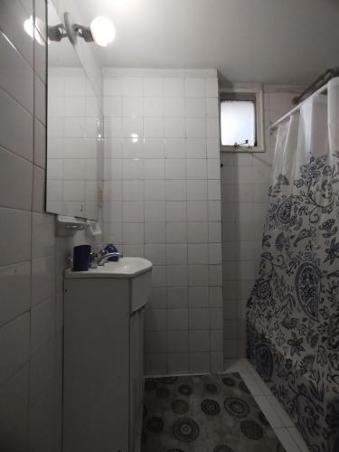 a bathroom with a shower and a sink and a shower curtain at Central y Comodo Departamento in Buenos Aires