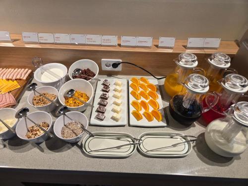 a table with plates of food and glasses on it at DIAMER Hotel Sokcho by AankStay in Yangyang