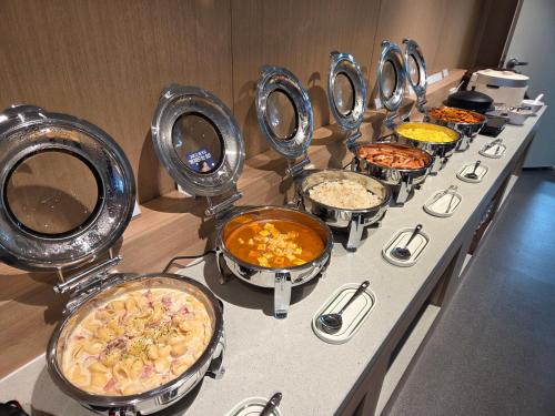 a buffet with many different types of food in bowls at DIAMER Hotel Sokcho by AankStay in Yangyang