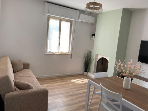 a living room with a table and a couch at Casale Giselle in Lanciano