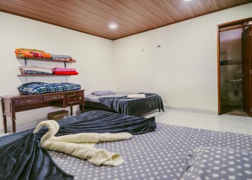 a room with two beds and a desk in it at Rancho Buenavista in Vergara