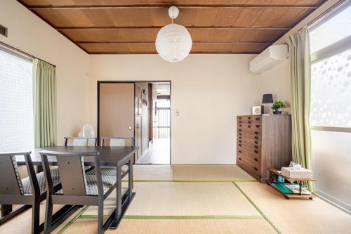 a dining room with a table and chairs at Small House Near Narita Airport in Shisui