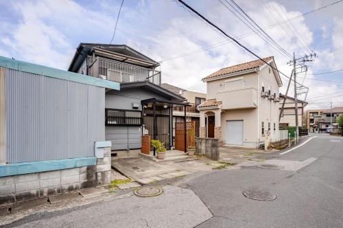 an empty street in front of a house at Small House Near Narita Airport in Shisui