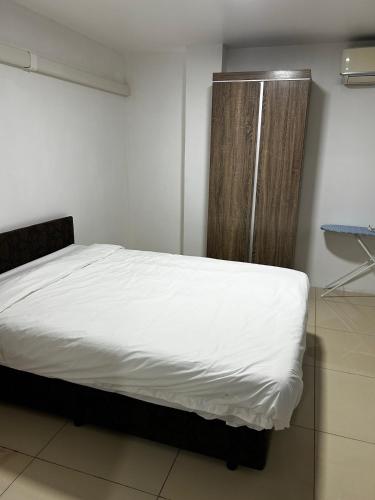 a bedroom with a bed with white sheets and a window at Easy Apartment-36Varani street flat1&flat4 in Suva