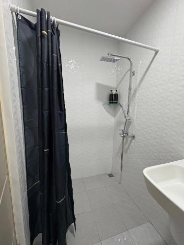 a shower with a black shower curtain in a bathroom at Iloilo Condo Perfect for Couple in Iloilo City