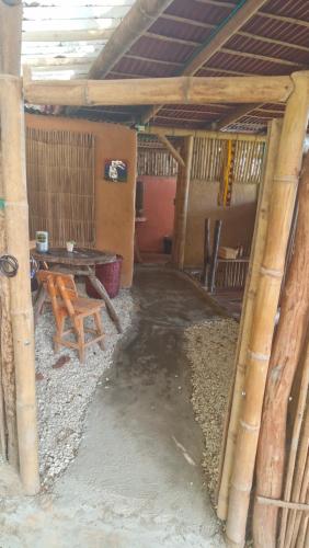 a room with a table and a bench in a building at Mountain Cabin, Minca in Santa Marta