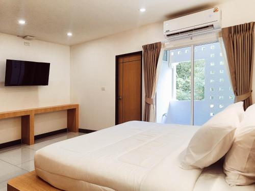Ένα ή περισσότερα κρεβάτια σε δωμάτιο στο Laksika Place Khao Rang
