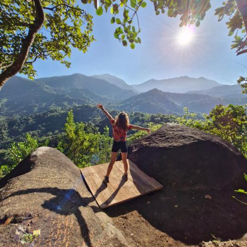 a woman standing on a rock on top of a mountain at Mountain Cabin, Minca in Santa Marta