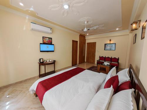 a bedroom with a large bed and a couch at Toshina Haveli in Jaipur