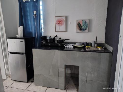 a kitchen with a counter with pots and pans on it at Duerme Relax 4 in Fajardo
