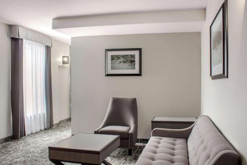 a living room with a couch and a chair at Chateau Moncton Trademark Collection by Wyndham in Moncton