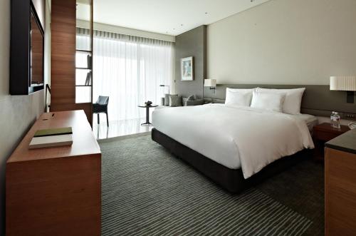 a hotel room with a large bed and a desk at Eslite Hotel in Taipei